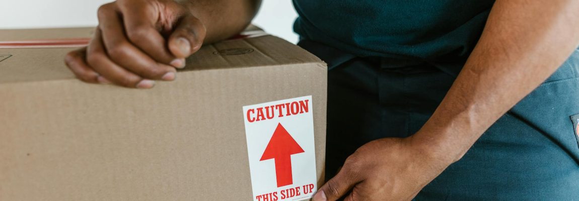 Professional movers packing boxes inside a home for a relocation service.